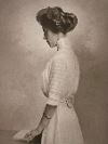 Harriet B. Kilton: Sepia-toned portrait of a woman in profile, wearing an updo hairstyle and a high-necked dress, standing with hands resting on a book or surface.