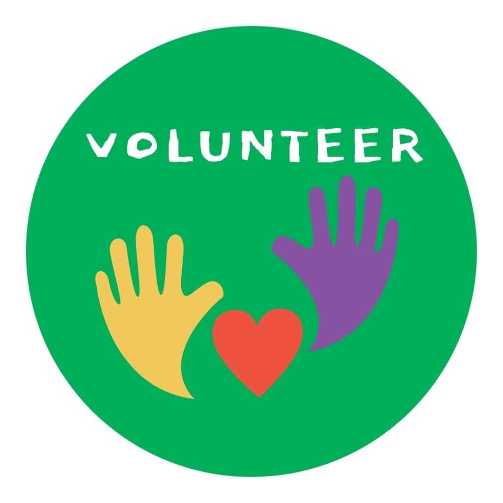 The image shows the word "VOLUNTEER" above yellow and purple handprints with a red heart between them on a green circular background.